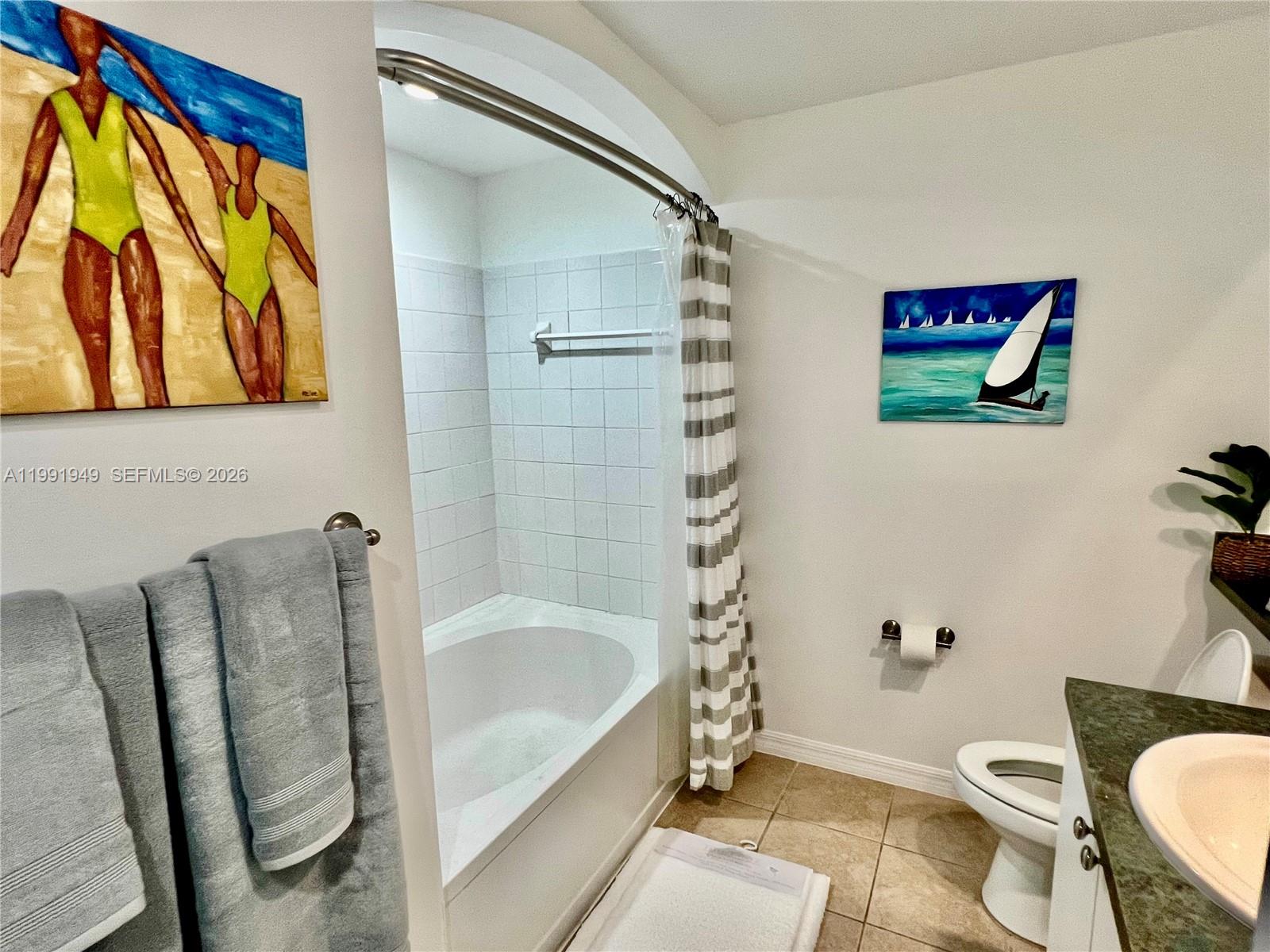 9172 Collins Avenue, Unit 305 Surfside, FL 33154 - Photo 10 of 37 a bathroom with a sink and a bathtub