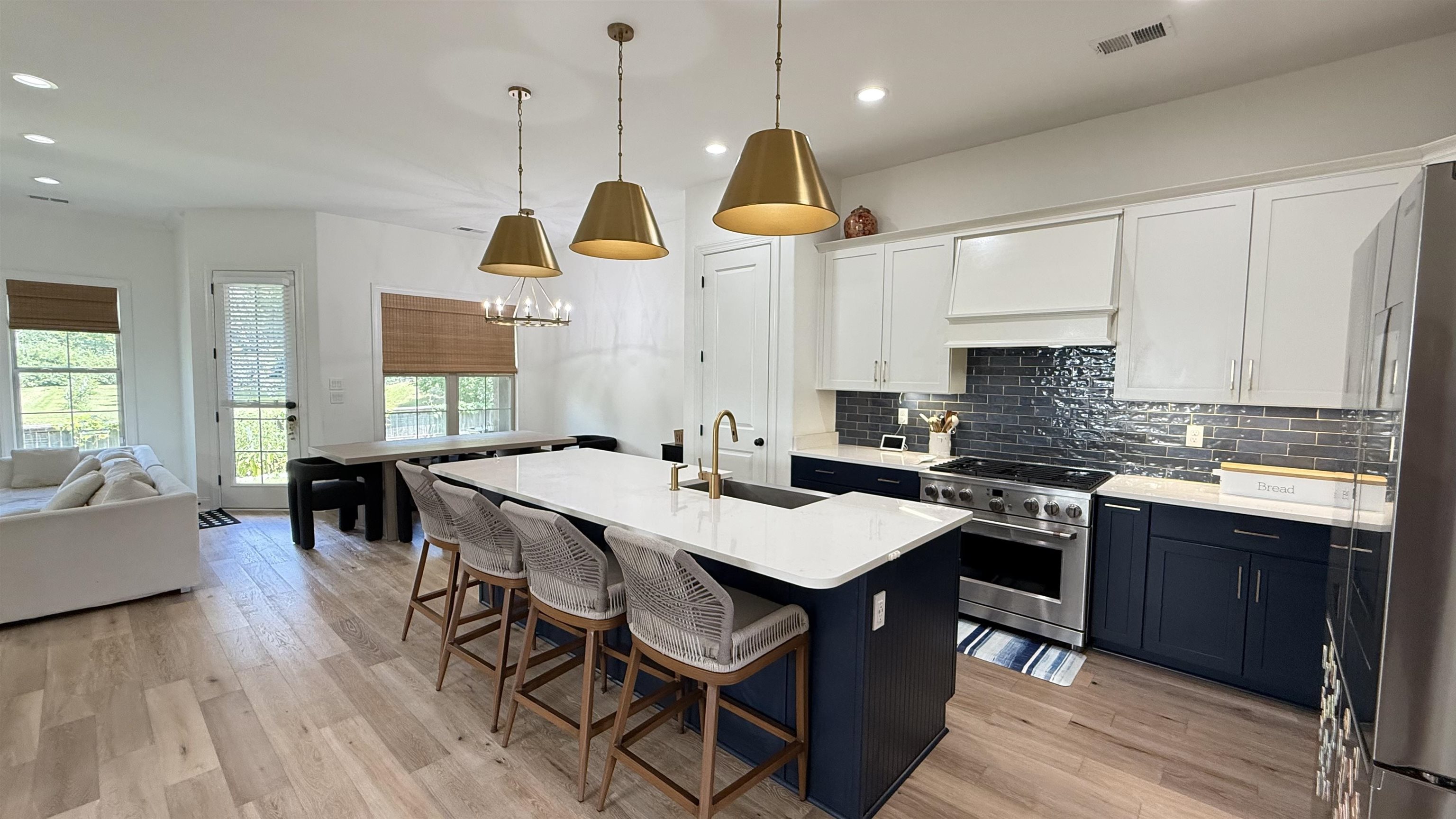1746 Chadwick Farms Loop North Collierville, TN 38017 - Photo 34 of 35 Kitchen with stainless steel appliances, open floor plan, light countertops, decorative backsplash, and a kitchen bar
