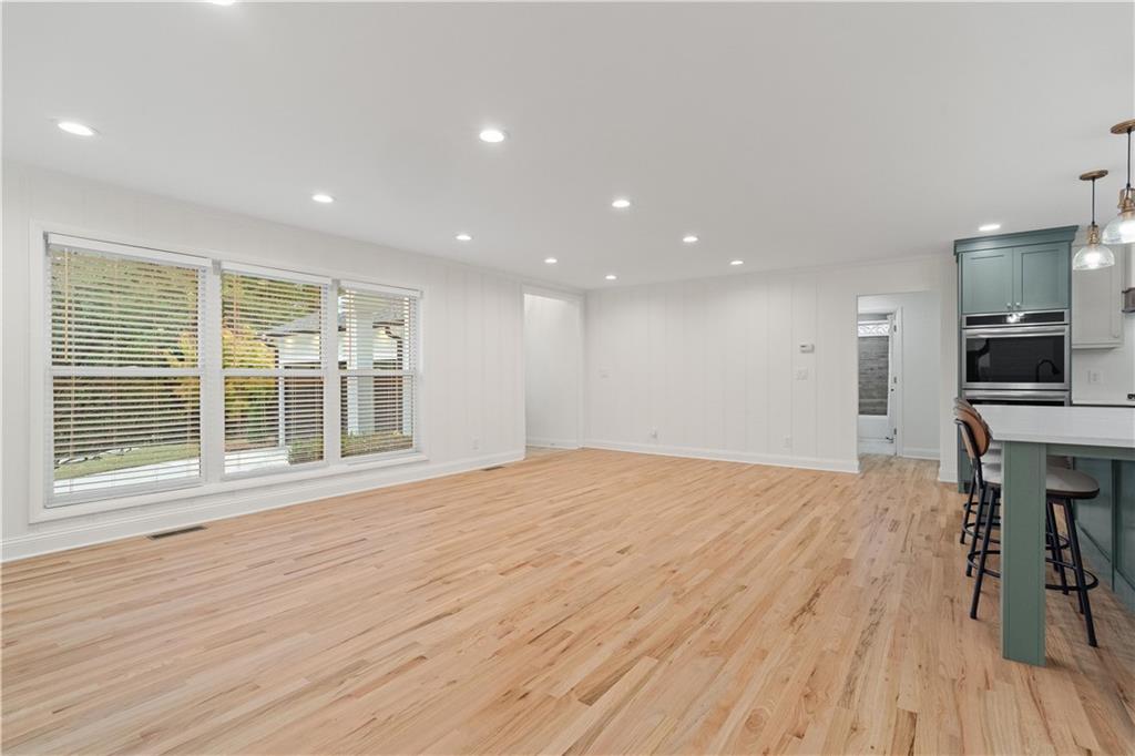 511 Boulevard Heights Calhoun, GA 30701 - Photo 12 of 69 a view of empty room with wooden floor and windows
