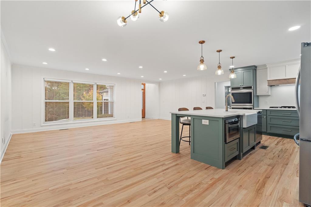 511 Boulevard Heights Calhoun, GA 30701 - Photo 13 of 69 a kitchen with kitchen island stainless steel appliances a stove top oven and a refrigerator