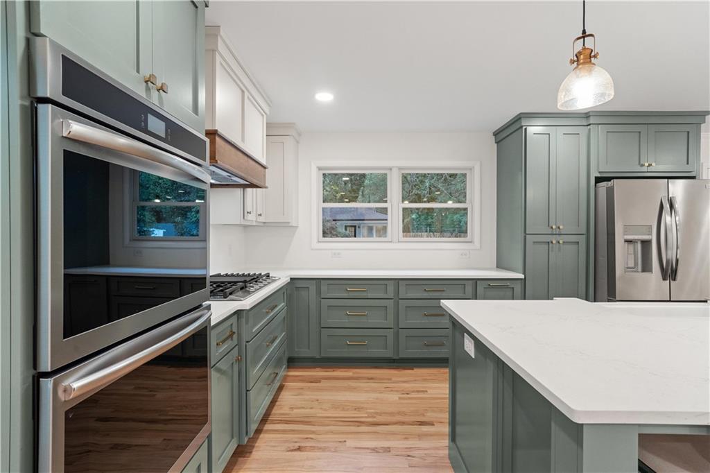 511 Boulevard Heights Calhoun, GA 30701 - Photo 20 of 69 a kitchen with stainless steel appliances granite countertop a sink and a refrigerator