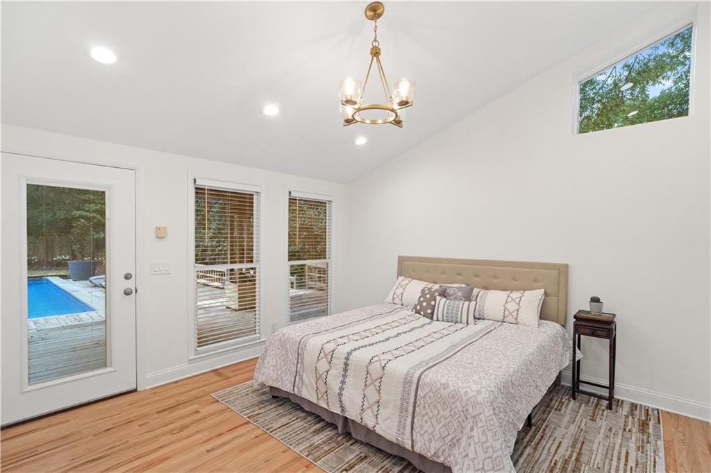 511 Boulevard Heights Calhoun, GA 30701 - Photo 22 of 69 a bedroom with a large bed chandelier and a window