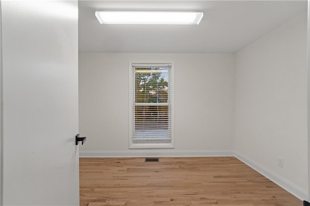 511 Boulevard Heights Calhoun, GA 30701 - Photo 29 of 69 a view of an empty room with wooden floor and a window