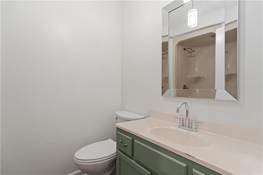 511 Boulevard Heights Calhoun, GA 30701 - Photo 48 of 69 a bathroom with a granite countertop sink a toilet and a mirror