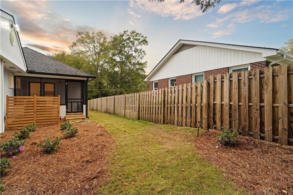 511 Boulevard Heights Calhoun, GA 30701 - Photo 62 of 69 a backyard of a house with plants and wooden fence