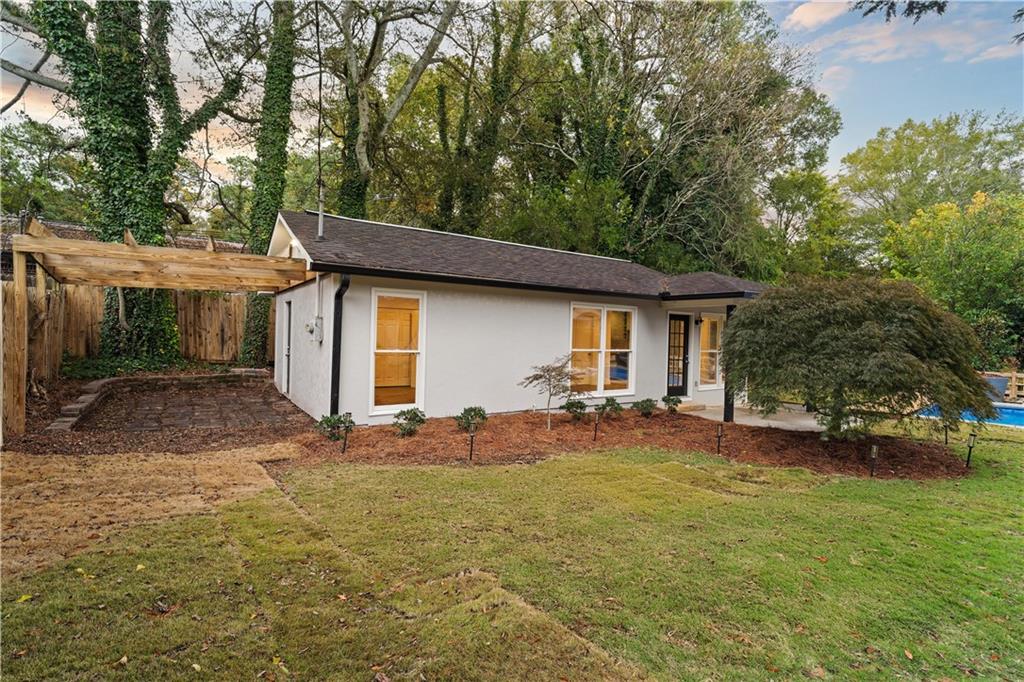 511 Boulevard Heights Calhoun, GA 30701 - Photo 7 of 69 a backyard of a house with table and chairs under an umbrella