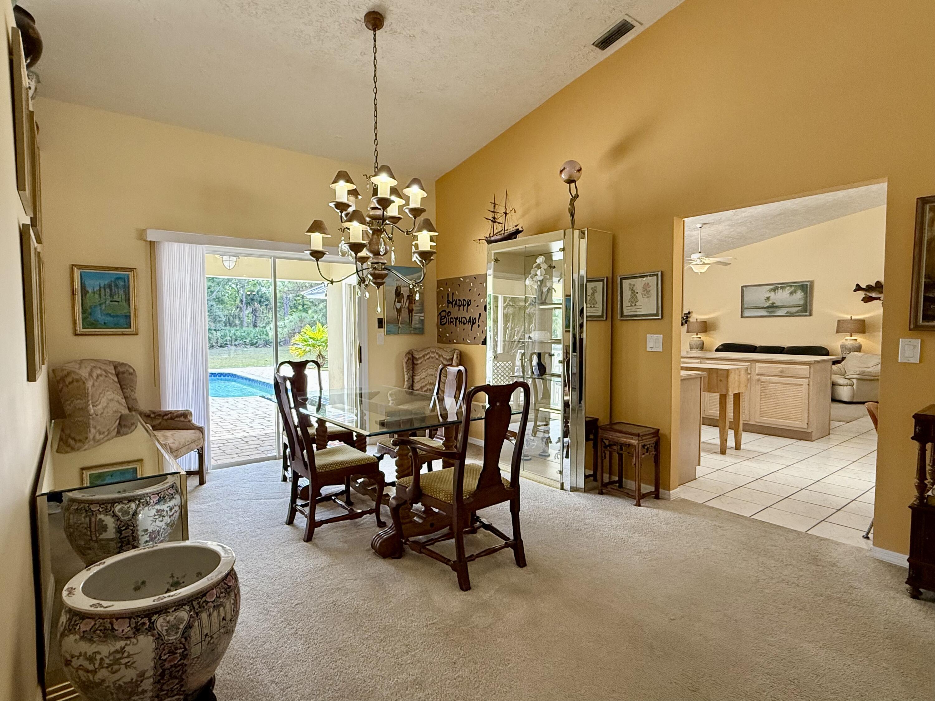 2884 Southeast Ranch Acres Circle Jupiter, FL 33478 - Photo 32 of 93 dining room and kitchen entrance