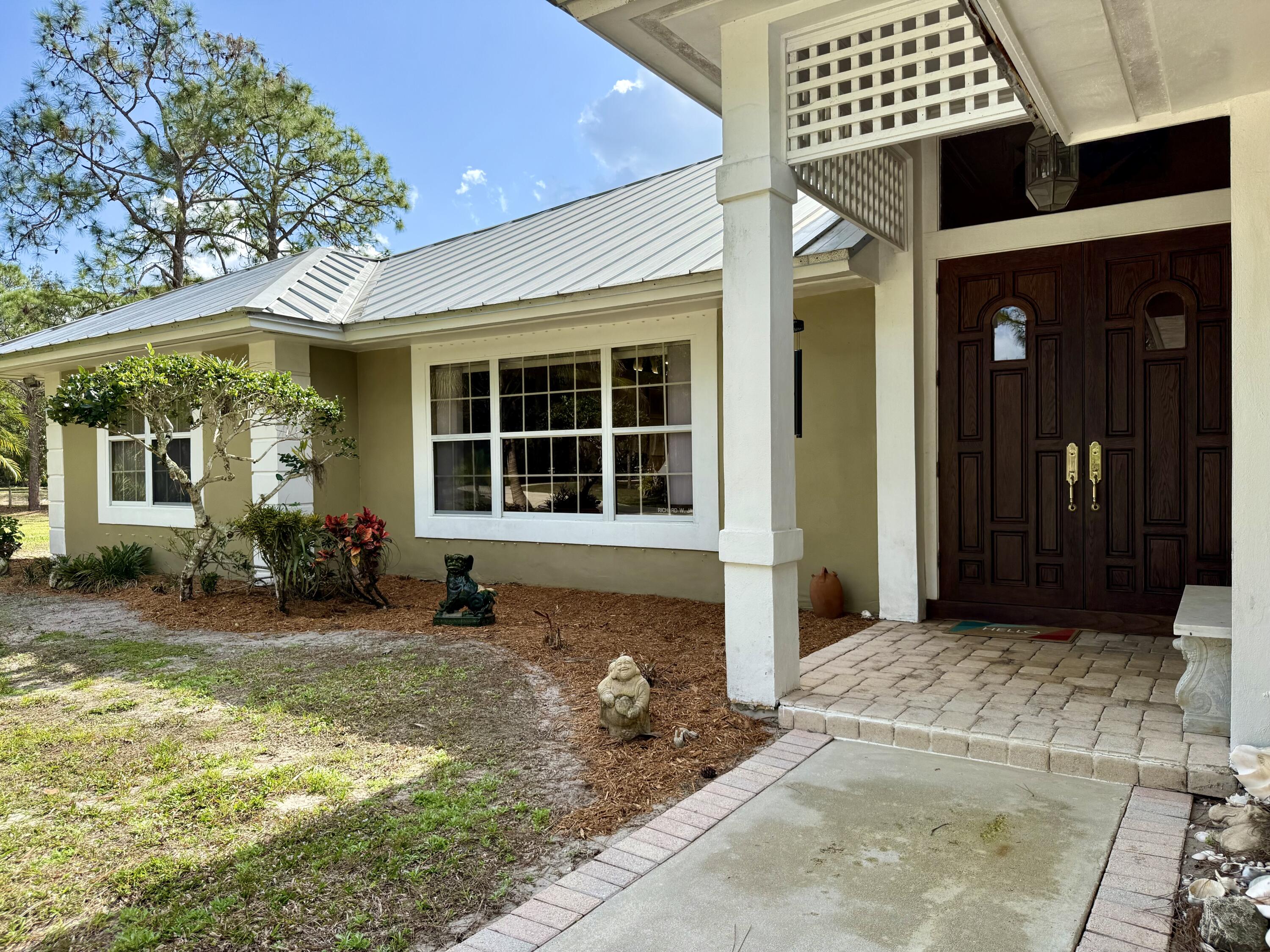 2884 Southeast Ranch Acres Circle Jupiter, FL 33478 - Photo 5 of 93 front door