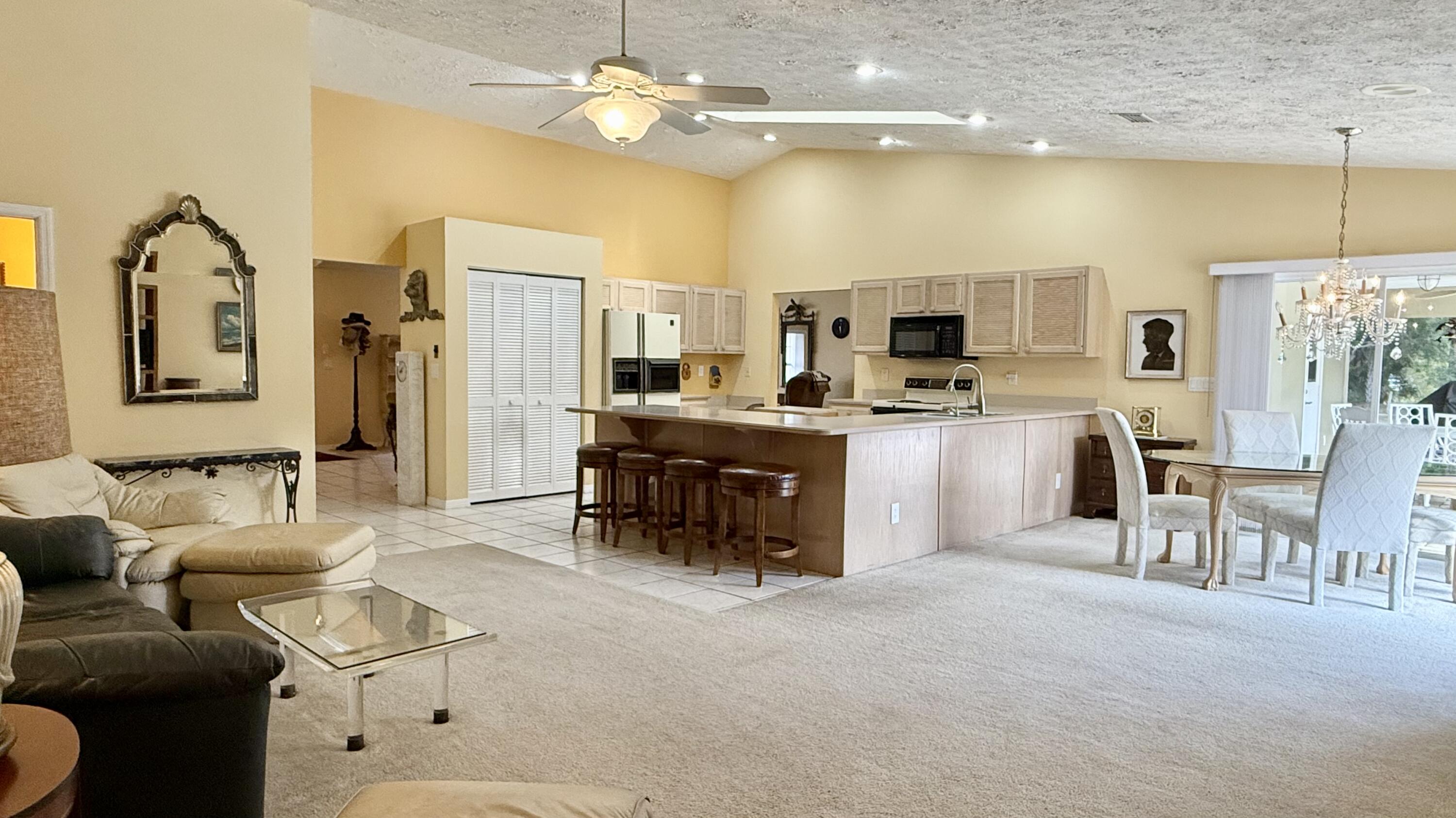 2884 Southeast Ranch Acres Circle Jupiter, FL 33478 - Photo 10 of 93 family room to kitchen