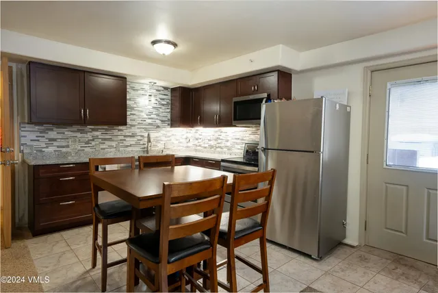 a kitchen with stainless steel appliances wooden cabinets and granite counter tops