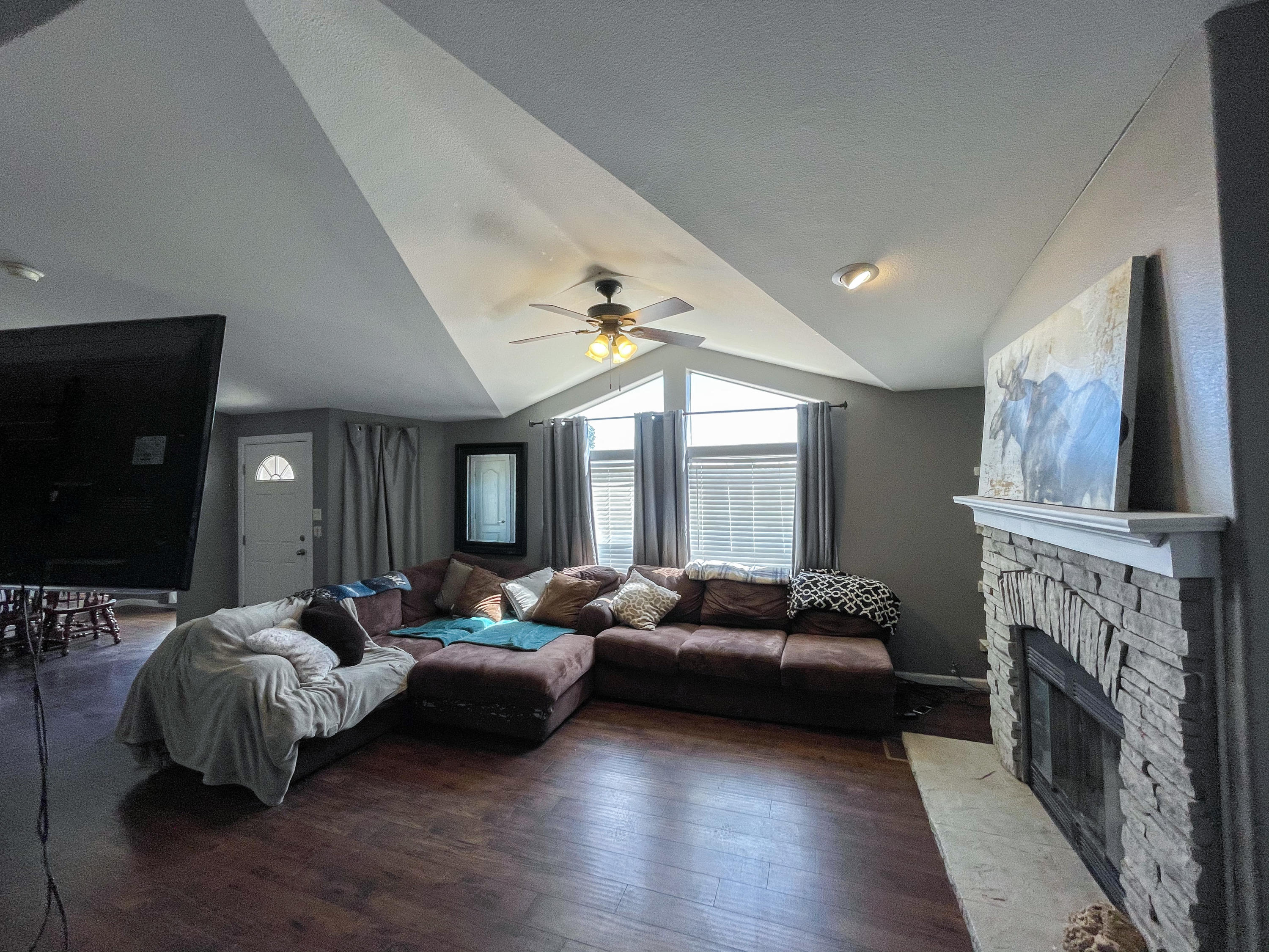 4647 Montiverde Road Mojave, CA 93501 - Photo 4 of 30 a living room with furniture a fireplace and a large window