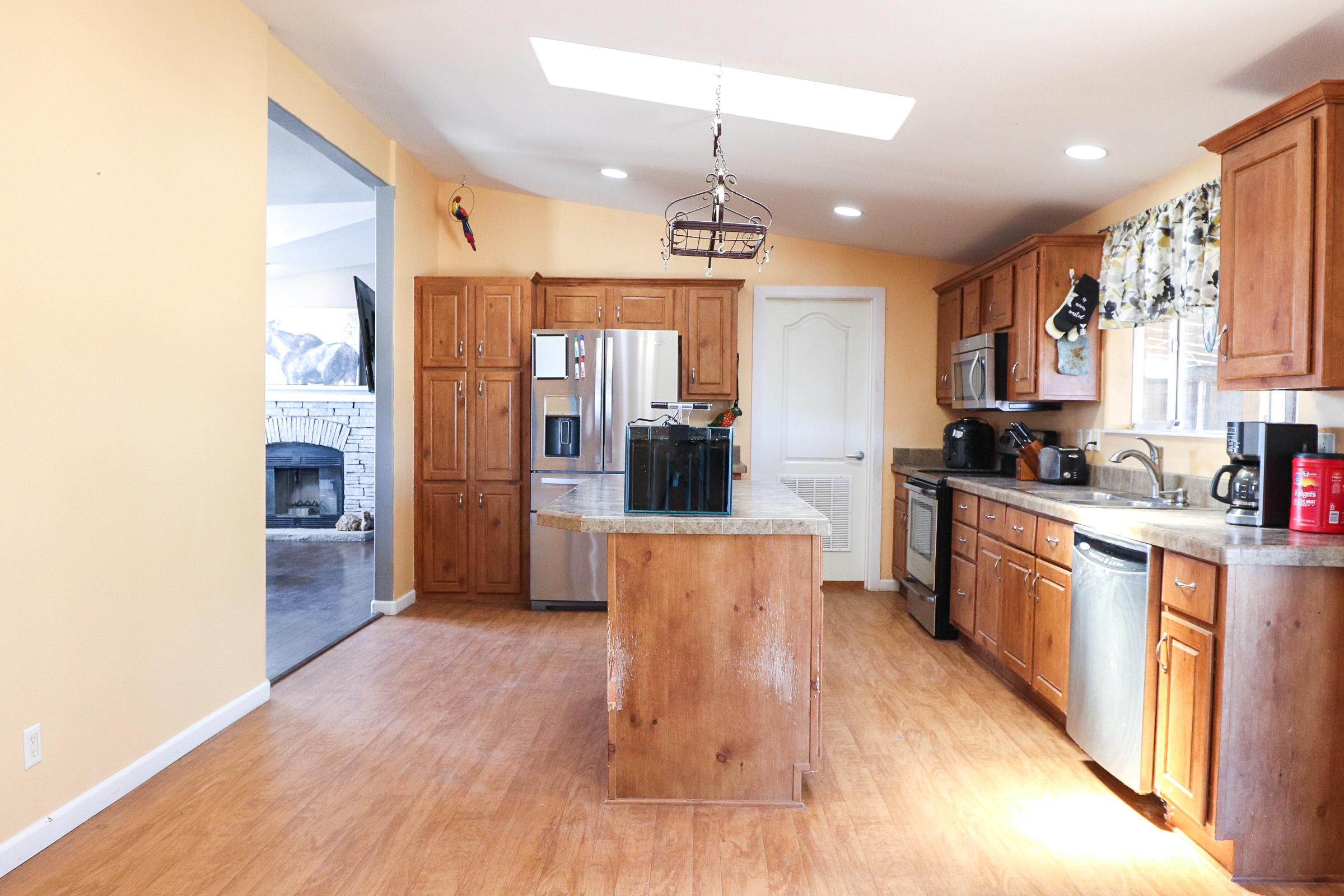 4647 Montiverde Road Mojave, CA 93501 - Photo 8 of 30 a large kitchen with cabinets wooden floor and stainless steel appliances