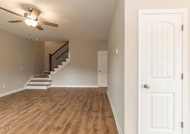wooden floor in an empty room with a chandelier