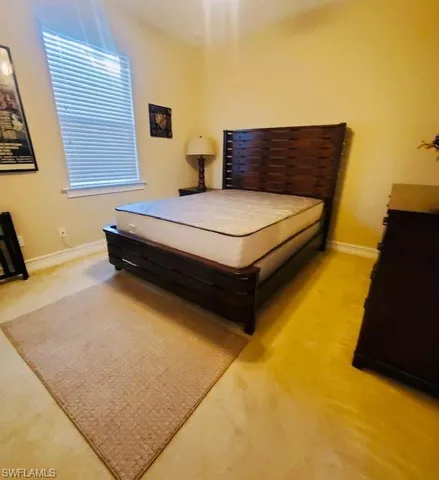 a bedroom with a bed and a night stand