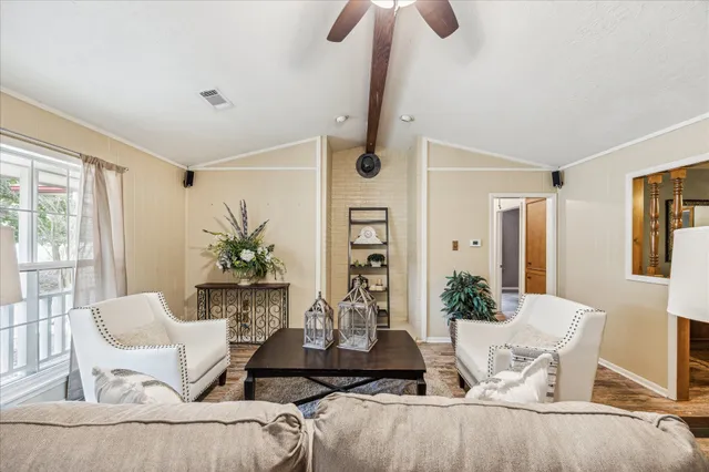 a living room with furniture and wooden floor