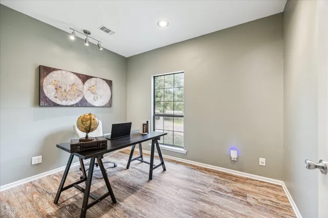 a workspace with furniture and wooden floor