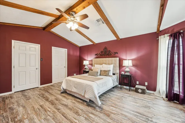 a bedroom with a bed and a ceiling fan