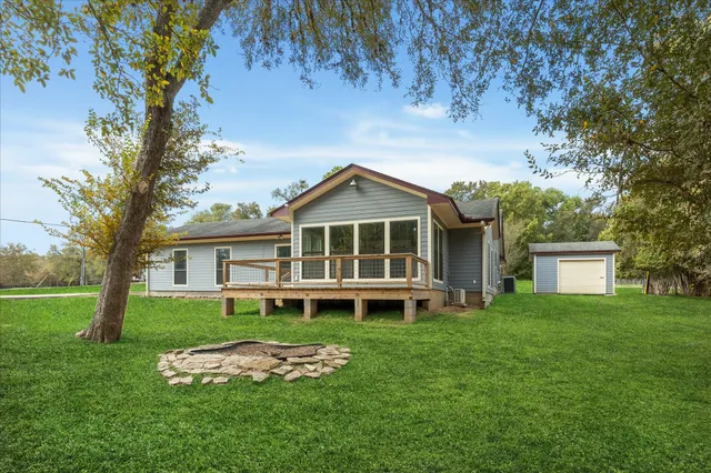 a front view of a house with a yard table and chairs