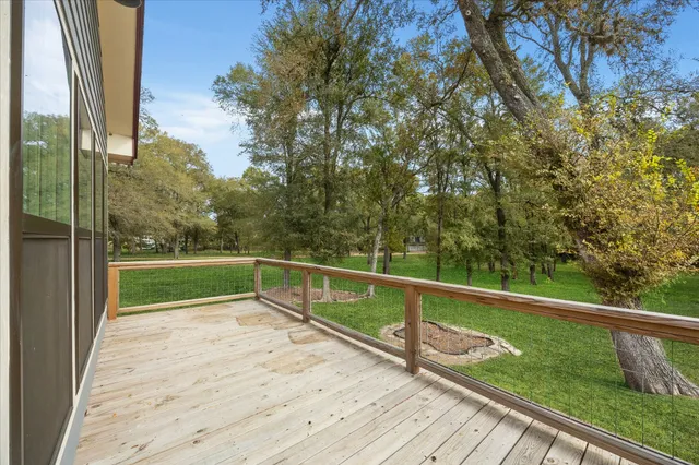 a view of a balcony with yard