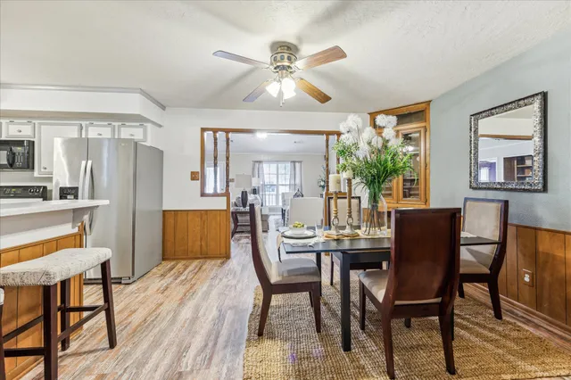 a dining room with furniture a window and wooden floor