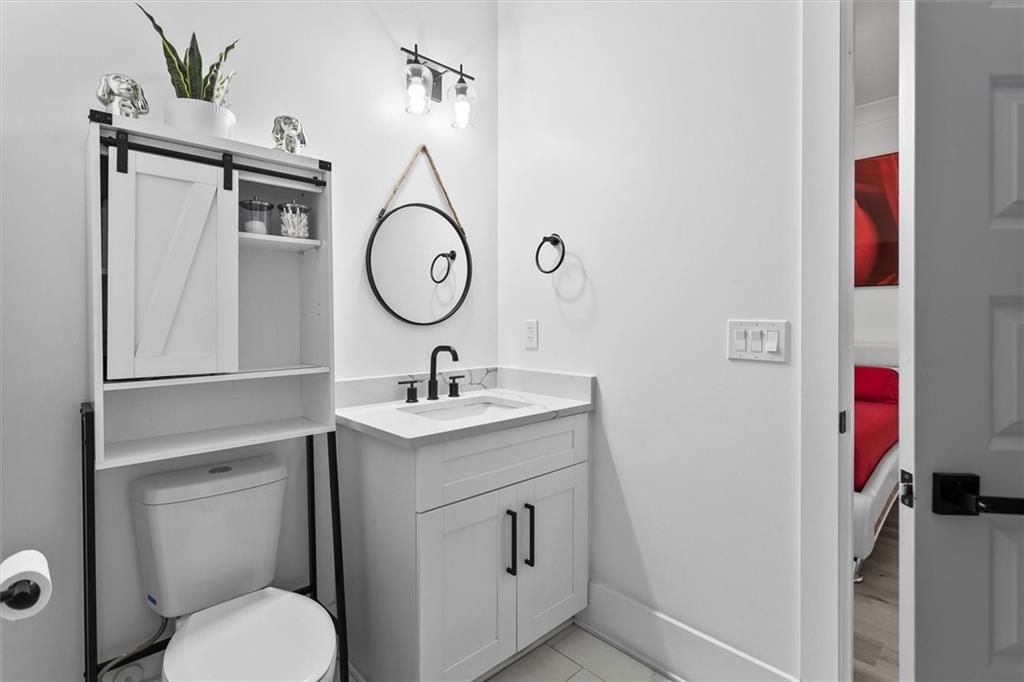 658 Rockbridge Road Northwest Lilburn, GA 30047 - Photo 40 of 61 a bathroom with a toilet sink and mirror