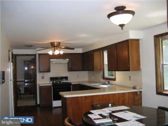 106 North Chapman Road Doylestown, PA 18901 - Photo 3 of 9 a kitchen with a refrigerator and a stove top oven