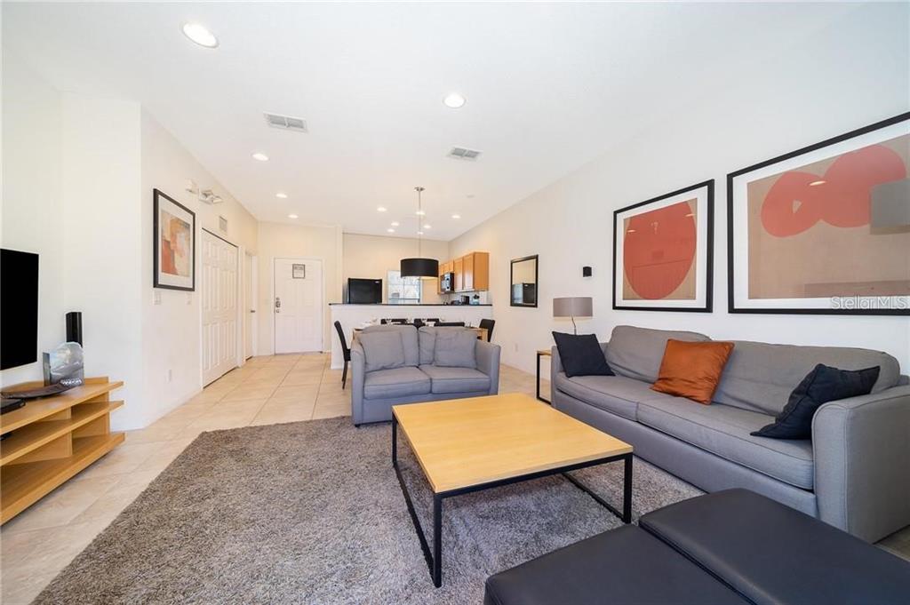 3007 White Orchid Road Kissimmee, FL 34747 - Photo 11 of 23 a living room with furniture and a flat screen tv