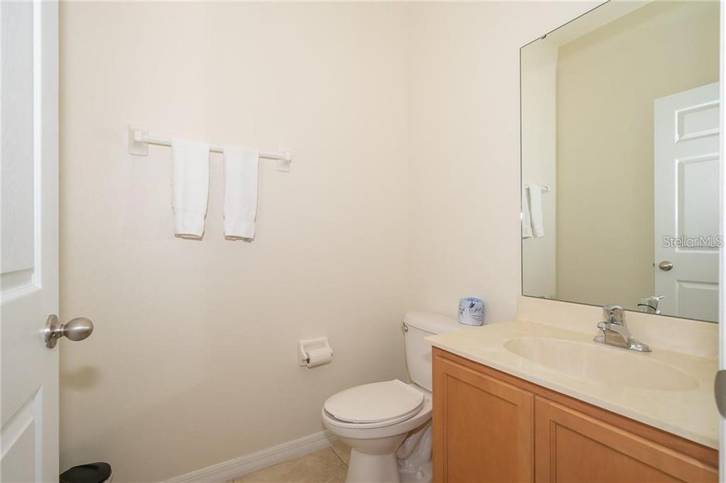 3007 White Orchid Road Kissimmee, FL 34747 - Photo 12 of 23 a bathroom with a granite countertop sink toilet and a mirror