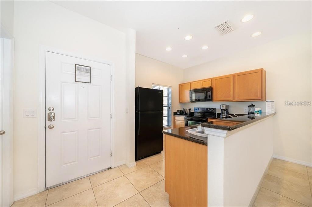 3007 White Orchid Road Kissimmee, FL 34747 - Photo 2 of 23 a kitchen with stainless steel appliances granite countertop a refrigerator and a stove top oven