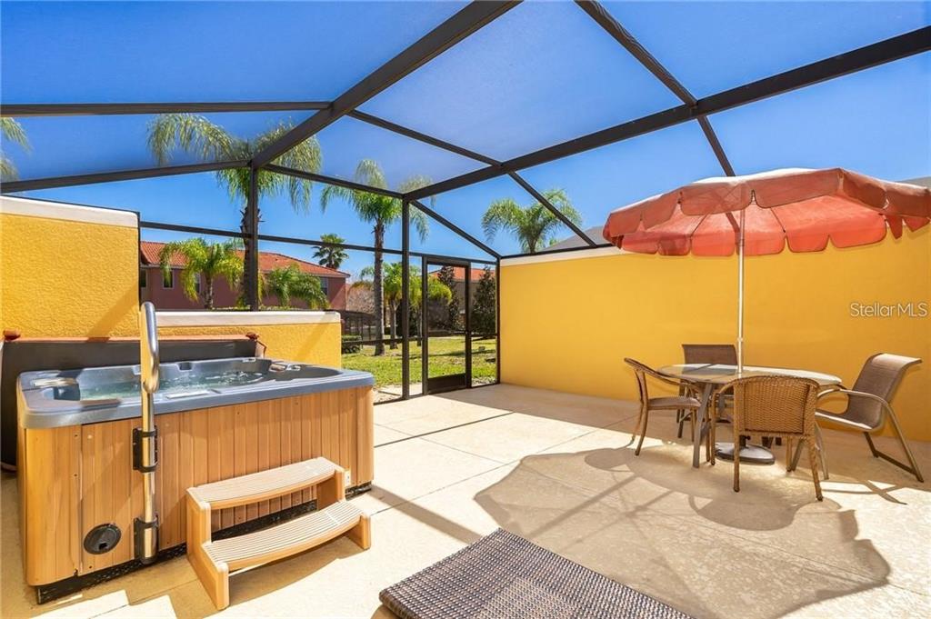 3007 White Orchid Road Kissimmee, FL 34747 - Photo 22 of 23 a view of a patio with a table and chairs under an umbrella