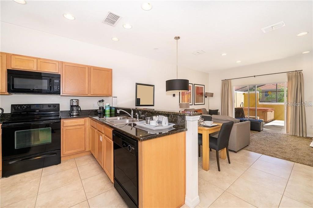 3007 White Orchid Road Kissimmee, FL 34747 - Photo 5 of 23 a kitchen with a stove cabinets and stainless steel appliances