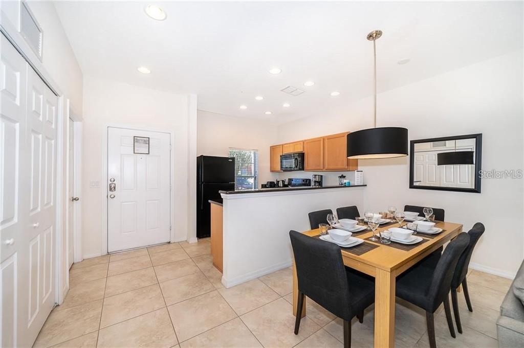 3007 White Orchid Road Kissimmee, FL 34747 - Photo 6 of 23 a living room with stainless steel appliances kitchen island granite countertop furniture and a view of kitchen