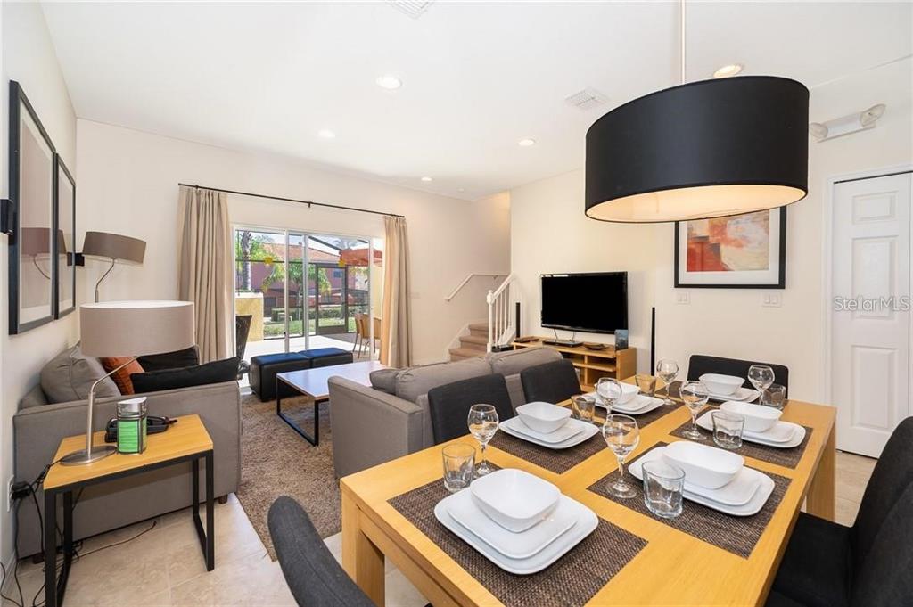 3007 White Orchid Road Kissimmee, FL 34747 - Photo 7 of 23 a living room with furniture and a flat screen tv