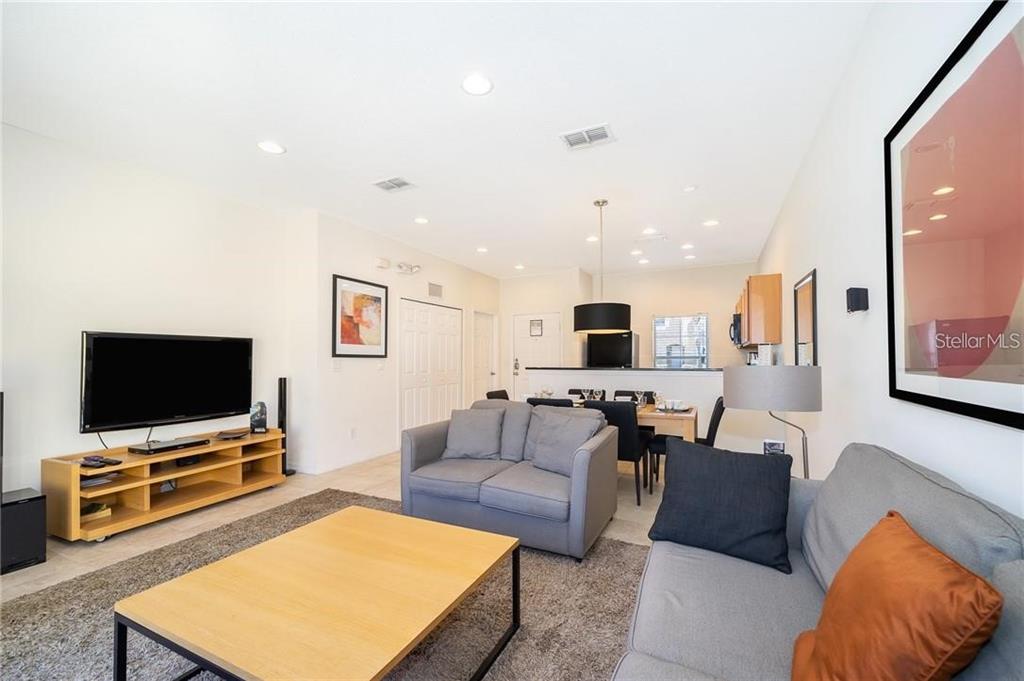 3007 White Orchid Road Kissimmee, FL 34747 - Photo 10 of 23 a living room with furniture and a flat screen tv