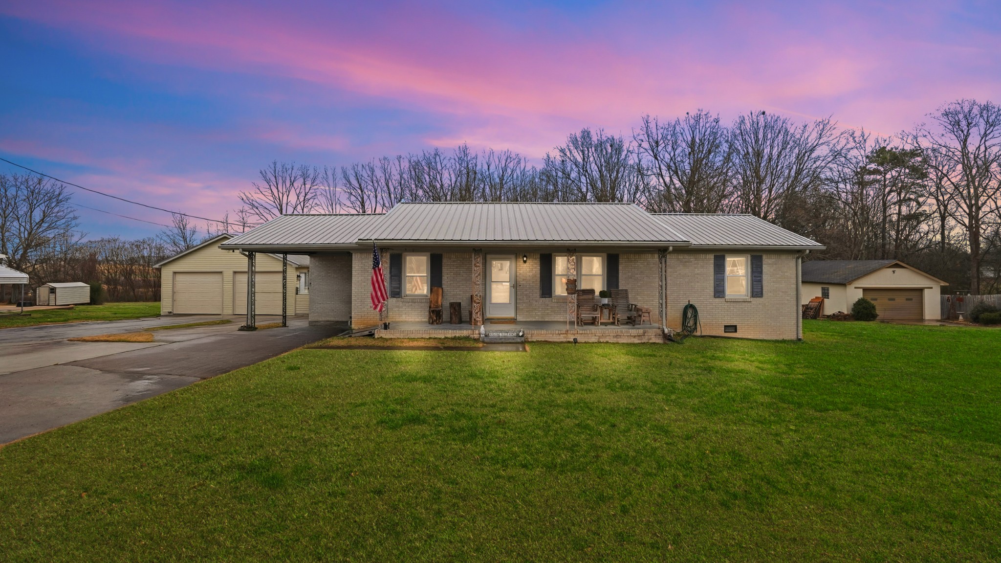 a front view of a house with swimming pool having outdoor seating