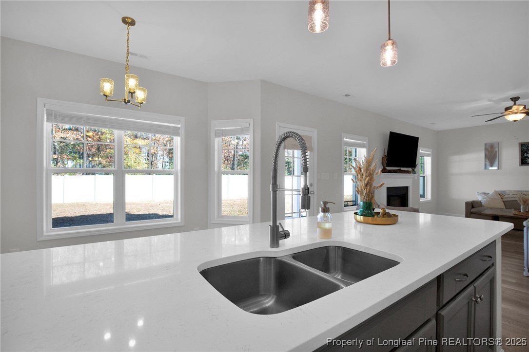 248 Rainy Beck Way Erwin, NC 28339 - Photo 16 of 44 a kitchen with a sink chandelier and living room