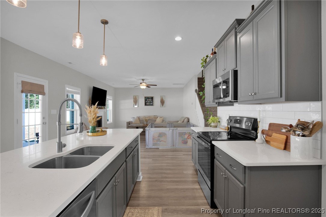 248 Rainy Beck Way Erwin, NC 28339 - Photo 18 of 44 a kitchen with counter top space a sink cabinets and stove top oven