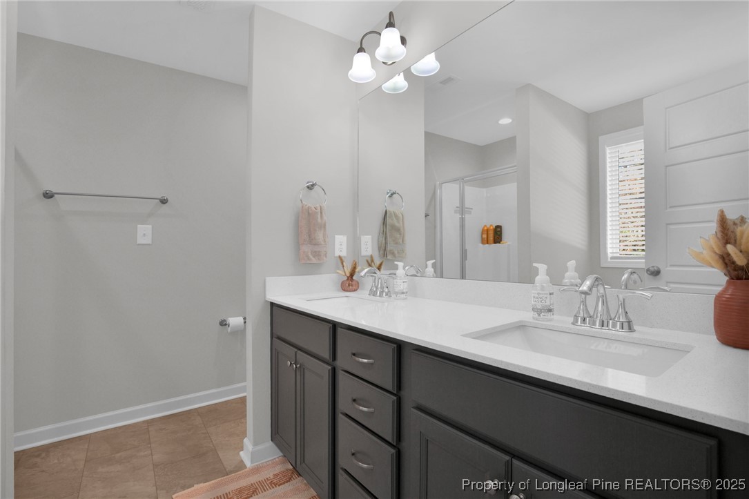 248 Rainy Beck Way Erwin, NC 28339 - Photo 33 of 44 a bathroom with a sink vanity and a mirror