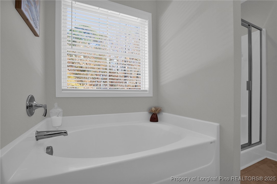 248 Rainy Beck Way Erwin, NC 28339 - Photo 35 of 44 a white bath tub sitting in a bathroom