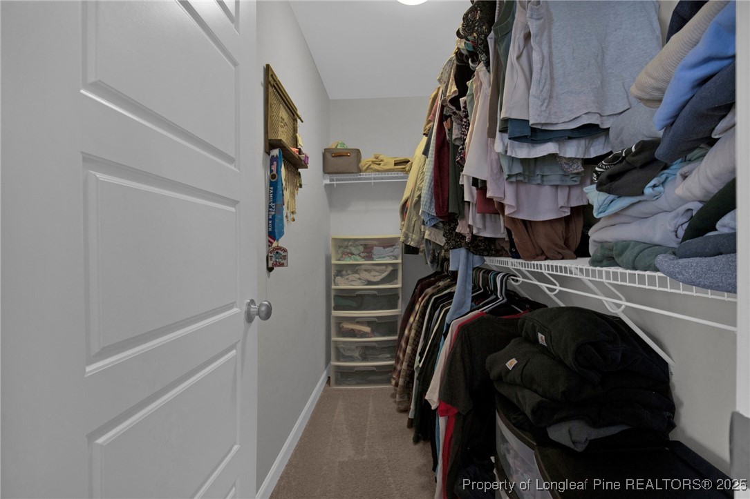 248 Rainy Beck Way Erwin, NC 28339 - Photo 36 of 44 a view of walk in closet with clothes and shoes