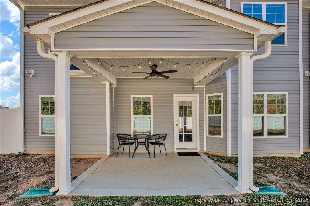 248 Rainy Beck Way Erwin, NC 28339 - Photo 40 of 44 a view of a patio with table and chairs and wooden floor