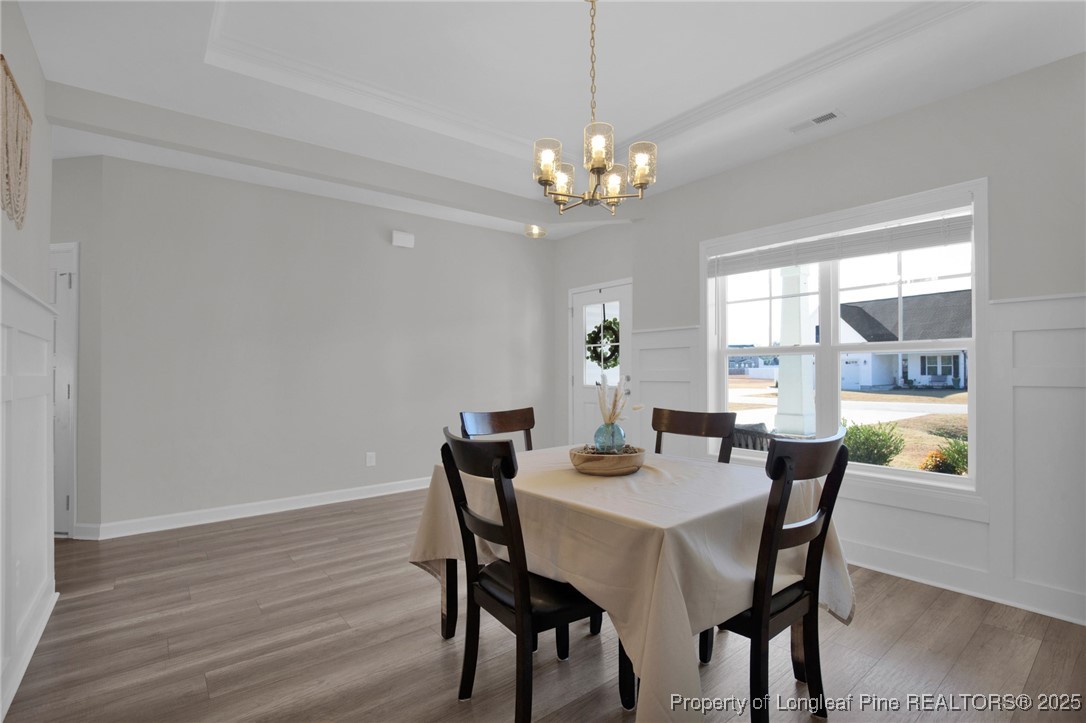 248 Rainy Beck Way Erwin, NC 28339 - Photo 6 of 44 a view of a dining room with furniture a chandelier and wooden floor