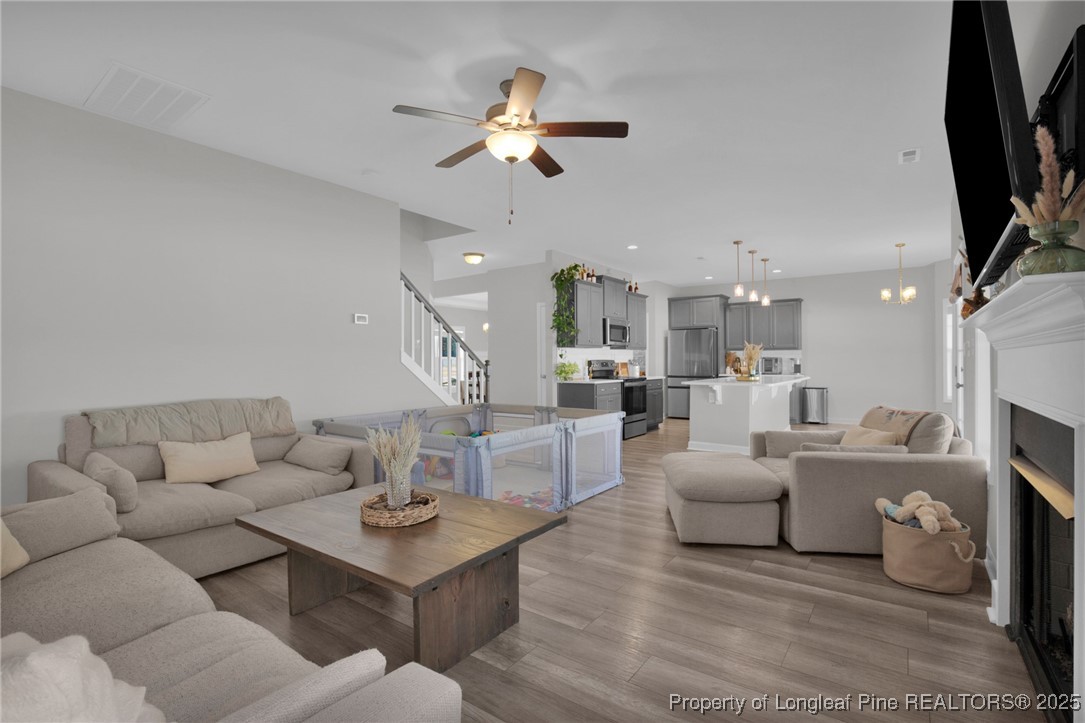 248 Rainy Beck Way Erwin, NC 28339 - Photo 9 of 44 a living room with furniture and a chandelier