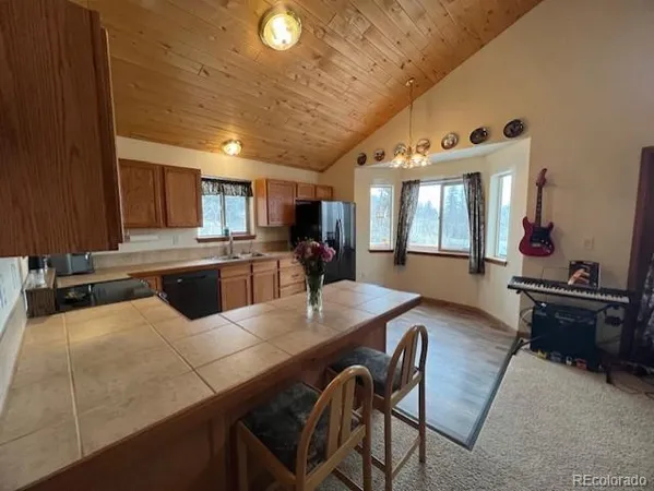 a large kitchen with a table and chairs in it