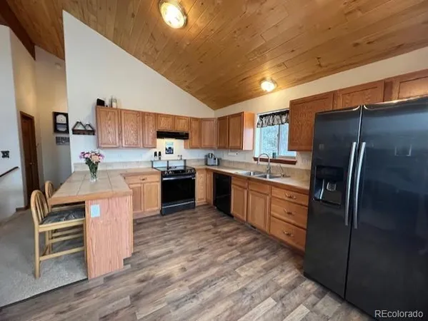a kitchen with stainless steel appliances granite countertop a refrigerator stove and oven
