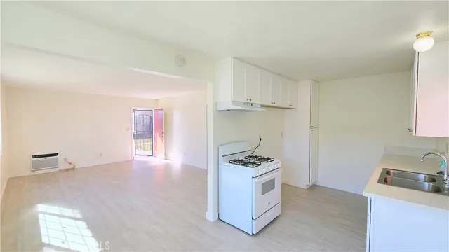 a kitchen with granite countertop a sink and a stove