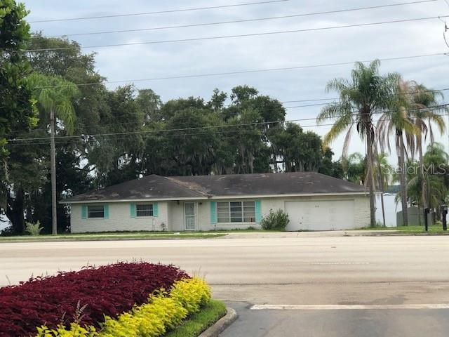 5110 North Socrum Loop Road Lakeland, FL 33809 - Photo 1 of 1 a front view of a house with a yard and palm trees