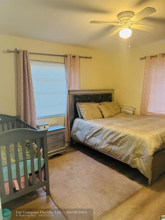 958 West 4th Street Riviera Beach, FL 33404 - Photo 11 of 13 a bedroom with a bed and a mirror