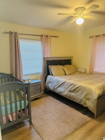 a bedroom with a bed next to a window