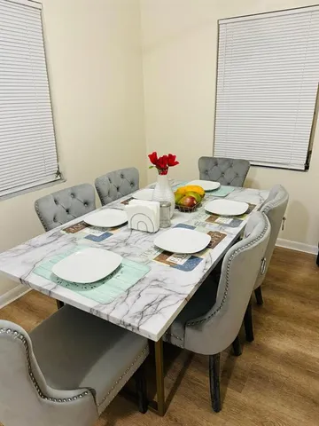 a dining room with furniture and wooden floor